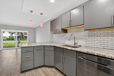 This condominium features an open kitchen, equipped with new - photo 8