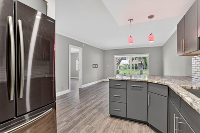 This condominium features an open kitchen, equipped with new - photo 9