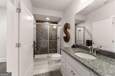AR Homes built this custom residence around one of Chattahoochee - photo 41