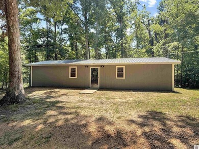 SECLUDED! Tucked away on 1.75 wooded acres, this cute 3-bedroom - photo 1