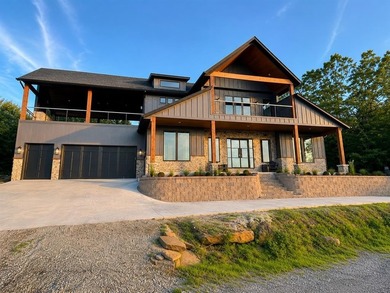Completed in 2025, this exceptional custom lake home in the - photo 1