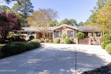 This charming brick ranch stands out on its corner lot within