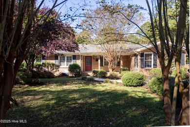 This charming brick ranch stands out on its corner lot within