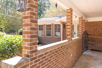 This charming brick ranch stands out on its corner lot within