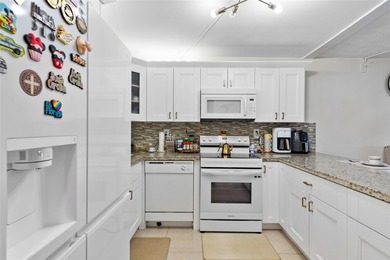 Welcome to this stunning 2-bed 2-bath condo located on the first - photo 1