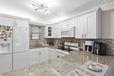 Welcome to this stunning 2-bed 2-bath condo located on the first - photo 6