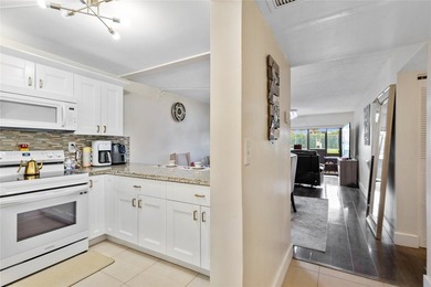 Welcome to this stunning 2-bed 2-bath condo located on the first - photo 7