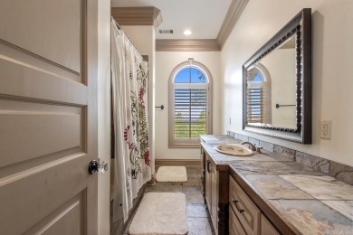 Tucked inside the gated Valley Falls Estates, this custom home