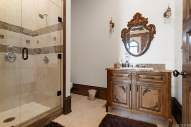 Tucked inside the gated Valley Falls Estates, this custom home