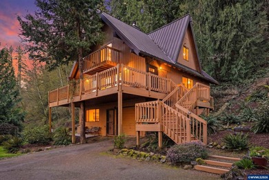 A custom chalet-style home surrounded by natural forest on - photo 1