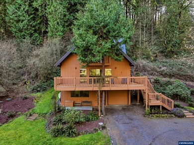 A custom chalet-style home surrounded by natural forest on - photo 5