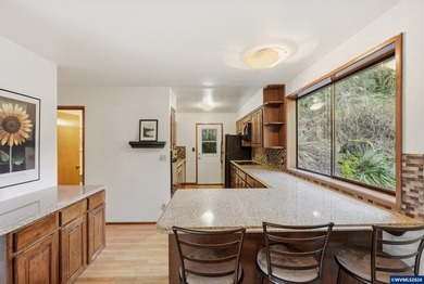 A custom chalet-style home surrounded by natural forest on - photo 6