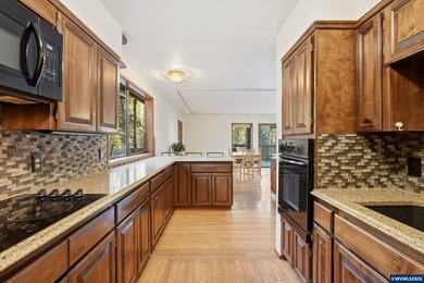 A custom chalet-style home surrounded by natural forest on - photo 7