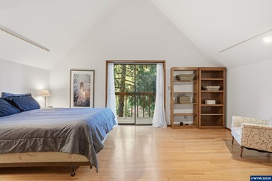 A custom chalet-style home surrounded by natural forest on - photo 9