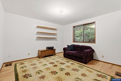 A custom chalet-style home surrounded by natural forest on - photo 10