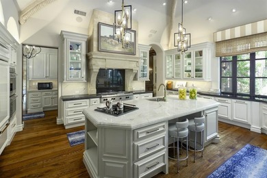 Rising behind a circle drive and flanked by Mediterranean