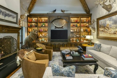 Rising behind a circle drive and flanked by Mediterranean