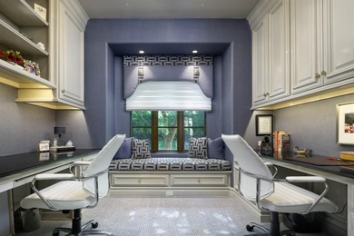 Rising behind a circle drive and flanked by Mediterranean