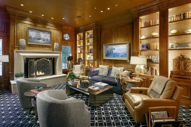 Rising behind a circle drive and flanked by Mediterranean