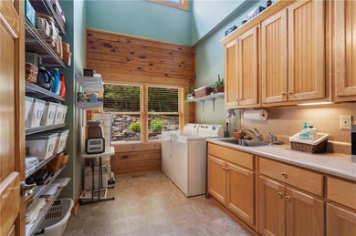 Welcome home to this custom builder's retreat with metal roof &