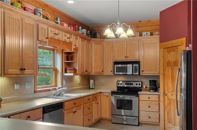 Welcome home to this custom builder's retreat with metal roof &