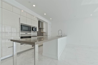 This exquisite 2 bed, 3-bath turnkey residence at the