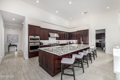 Set on a 1-acre site, this custom estate in the Boulder Ranch