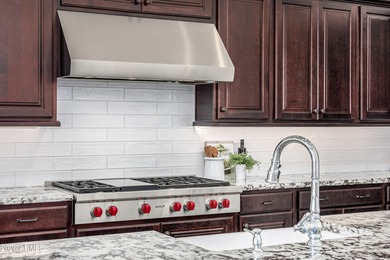 Set on a 1-acre site, this custom estate in the Boulder Ranch