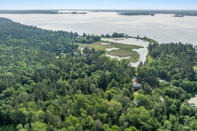 Nestled among mature pines and along a peaceful channel, the - photo 11