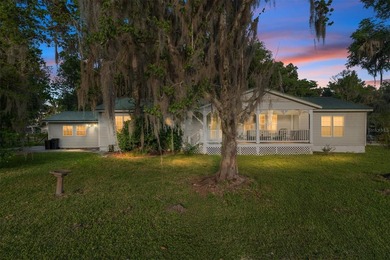 Tucked away among majestic live oaks and native palms, this - photo 1