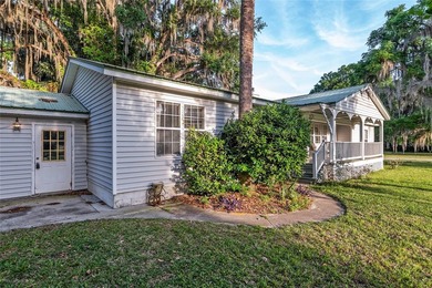 Tucked away among majestic live oaks and native palms, this - photo 7