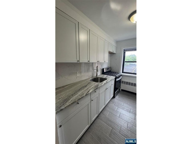 Welcome to Unit A7 at 2335 Hudson Terrace, a renovated 2-bedroom