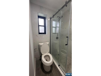 Welcome to Unit A7 at 2335 Hudson Terrace, a renovated 2-bedroom