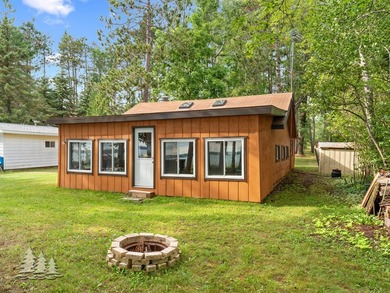 Tucked along 50 feet of coveted West Twin Lake frontage, this - photo 1