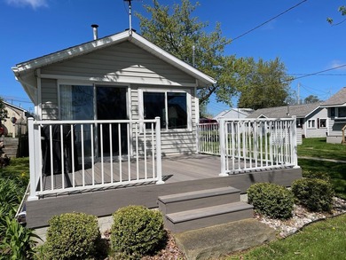 Nestled on the picturesque west shore of Houghton Lake, the - photo 2