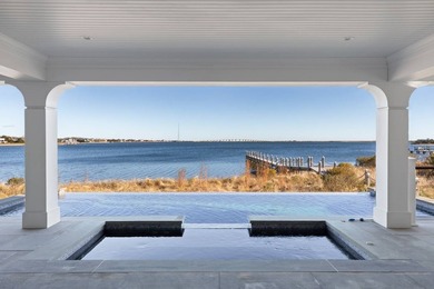 Set on 175 feet of private sandy beachfront with a 136' dock - photo 12