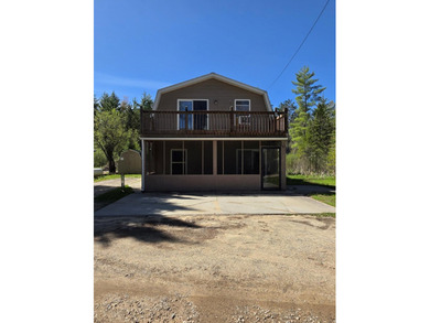 Escape to Northern Michigan with this inviting riverfront - photo 1