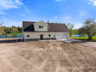 Brand new construction on the beautiful Cheboygan River! Enjoy - photo 2