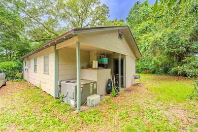 Nestled beneath a canopy of mature oaks and tucked away on a - photo 17