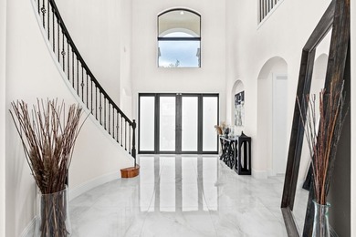 Beyond double entry doors, a remodeled iron staircase frames - photo 22