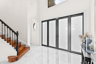 Beyond double entry doors, a remodeled iron staircase frames - photo 23