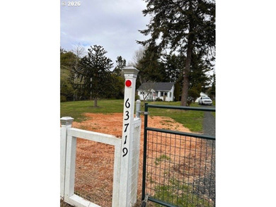 Nearly one-acre level setting with a charming white fence entry - photo 2