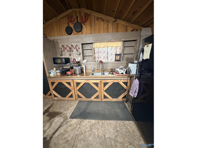 Make this cabin-style tiny home your lake area retreat. It sits - photo 13
