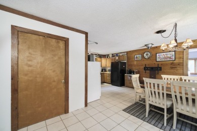 With its knotty pine wood finishes and tree shaded setting, this