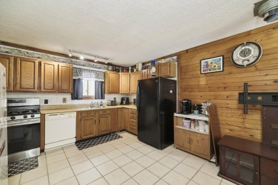 With its knotty pine wood finishes and tree shaded setting, this