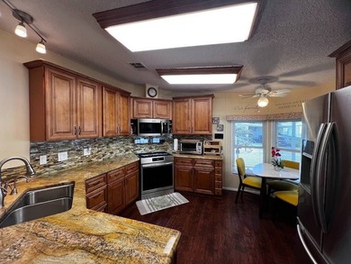 This well-maintained home features a membrane roof over the home - photo 6