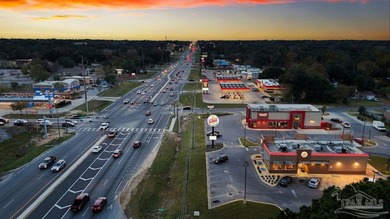 1.3 acre parcel with over 200 feet of road frontage on 9-Mile Rd - photo 1