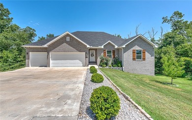Tucked into the wooded hills of Bella Vista, this home delivers - photo 1