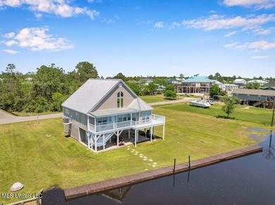 Located on a spacious waterfront lot in Bay St. Louis, this - photo 1