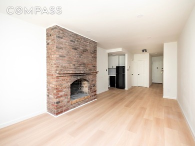 A pre-war brick fireplace, south-facing courtyard light, and a - photo 2
